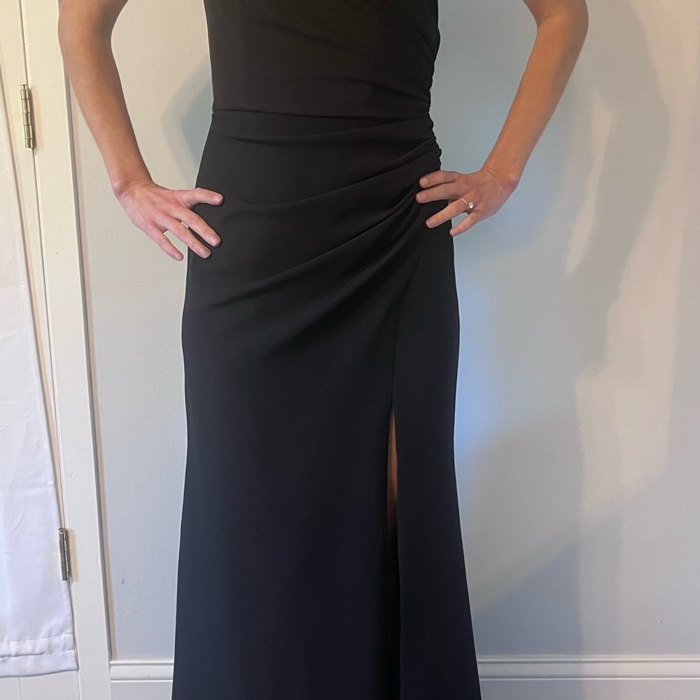 Black chiffon lined halter top formal dress with slit up the side.